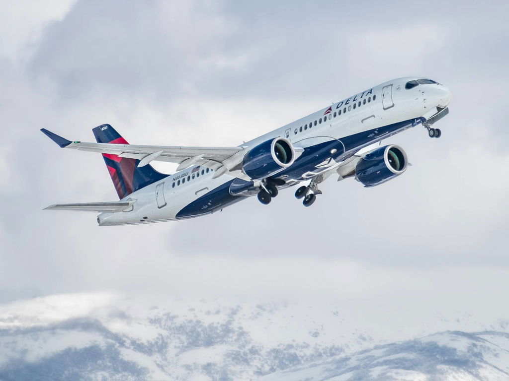 Delta plane in the air above mountains