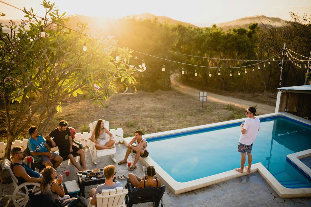 group of friends celebrating by a pool