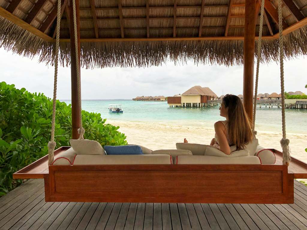 person sitting by the beach at a hotel