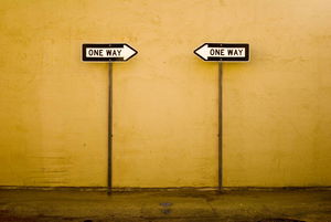 two one-way signs pointing at each other