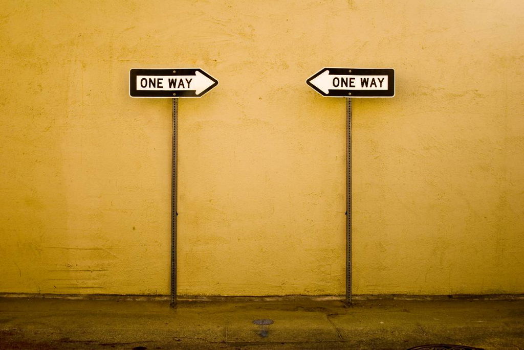 two one-way signs pointing at each other