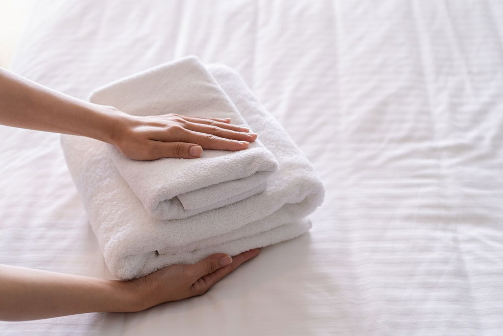 hotel towels on bed